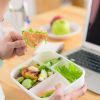 Man Eating from Lunch Box in Office